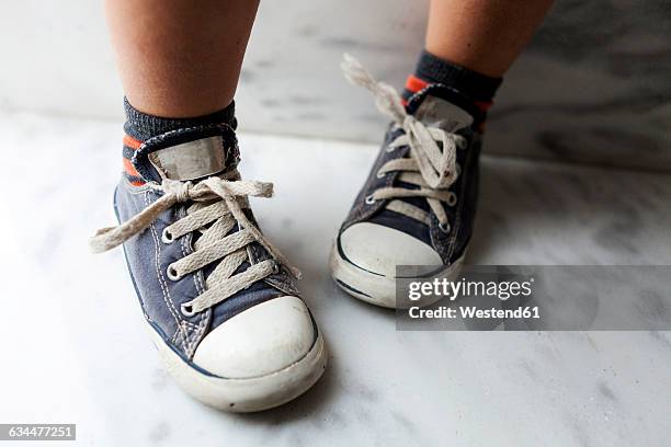 close-up of boy wearing sneakers - stringa foto e immagini stock