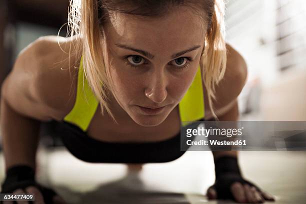 woman doing push-ups in gym - gym determination stock pictures, royalty-free photos & images