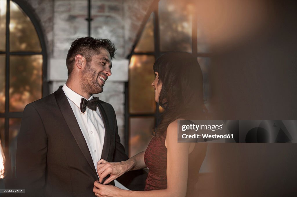 Couple in elegant clothing getting dressed