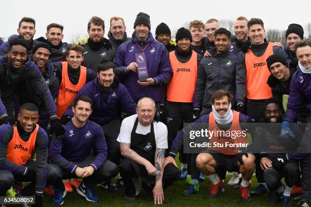 Swansea City manager Paul Clement with his Barclays Manager of the Month award and players and staff at Swansea City's training ground at Fairwood on...