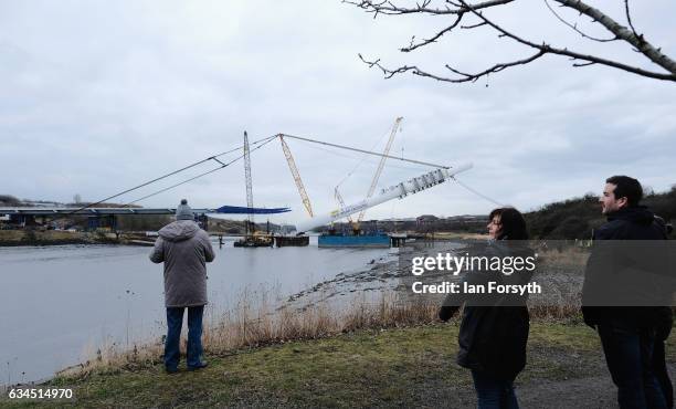 Members of the public watch as the final 100 metre centrepiece of Sunderland's new River Wear crossing is lifted into place on February 10, 2017 in...