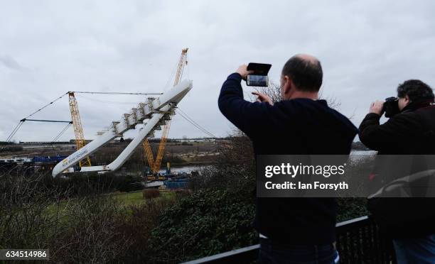 Members of the public watch as the final 100 metre centrepiece of Sunderland's new River Wear crossing is lifted into place on February 10, 2017 in...