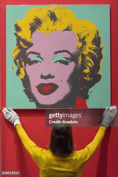 Museum staff makes final adjustments to a selection of ten colour Andy Warhol screen prints featuring Marilyn Monroe installed in the British Museums...