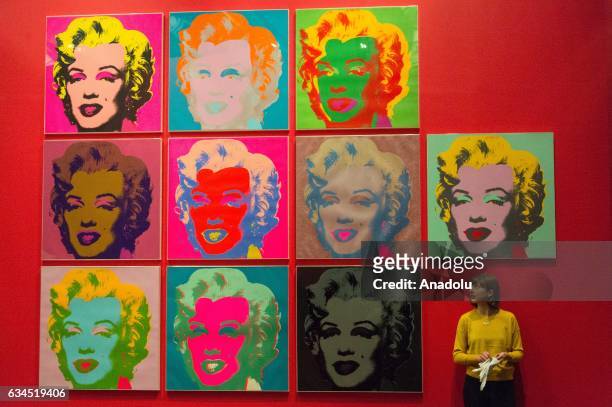 Museum staff makes final adjustments to a selection of ten colour Andy Warhol screen prints featuring Marilyn Monroe installed in the British Museums...