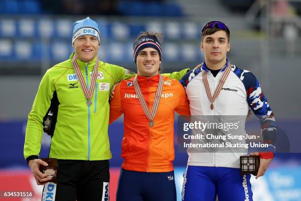 Second place Nico Ihle of Germany, first place Jan Smeekens of Netherlands and third place Ruslan Murashov of Russia celebrate during a medal...