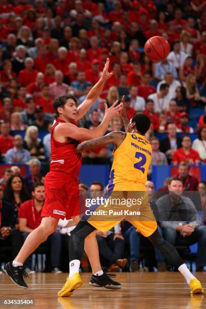 Damian Martin of the Wildcats passes the ball against Greg Whittington of the Kings during the round 19 NBL match between the Perth Wildcats and the...