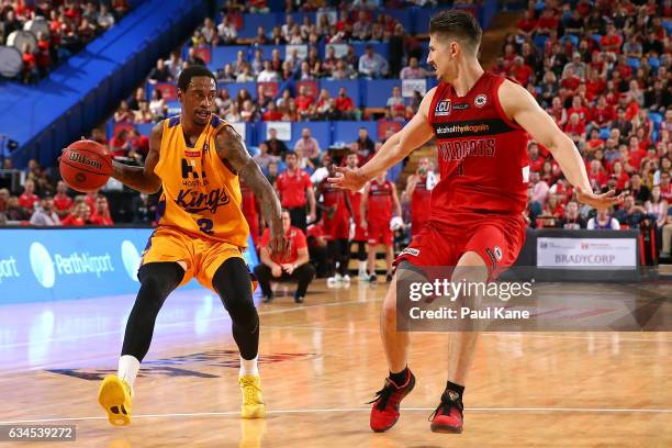 Greg Whittington of the Kings controls the ball against Greg Hire of the Wildcats during the round 19 NBL match between the Perth Wildcats and the...