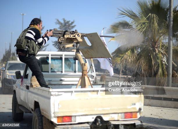 Free Syrian Army fighter fires with a machine gun installed on a truck in Al-Bab town of Aleppo during the 171th day of the "Operation Euphrates...