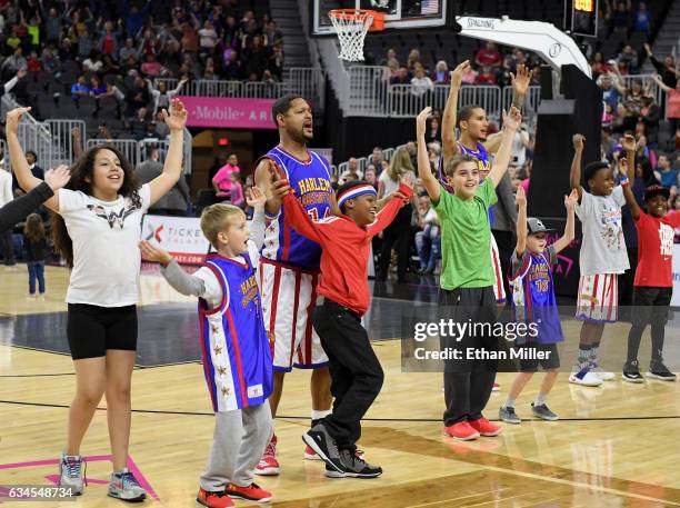 Chris "Handles" Franklin and James "Torch" Barrott of the Harlem Globetrotters perform the song "Y.M.C.A." with fans on the court during the team's...