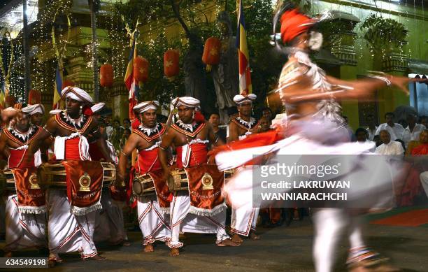 Sri Lankan traditional Kandyan dancers perform during a procession in front of the Gangarama Temple as part of the Navam Perahera festival in Colombo...