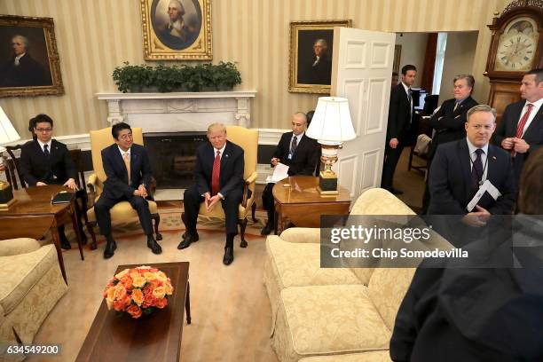 President Donald Trump and Japanese Prime Minister Shinzo Abe pose for photographs before bilateral meetings in the Oval Office at the White House...