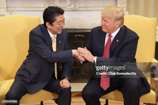 President Donald Trump and Japanese Prime Minister Shinzo Abe pose for photographs before bilateral meetings in the Oval Office at the White House...