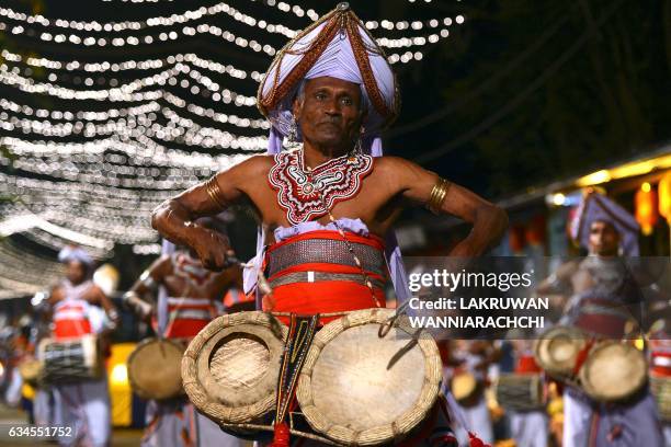 Sri Lankan traditional Kandyan dancers perform during a procession in front of the Gangarama Temple as part of the Navam Perahera festival in Colombo...
