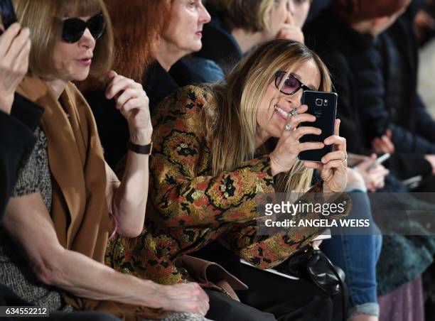 Actress Sarah Jessica Parker takes a photo at the Calvin Klein show at New York Fashion Week on February 10, 2017.