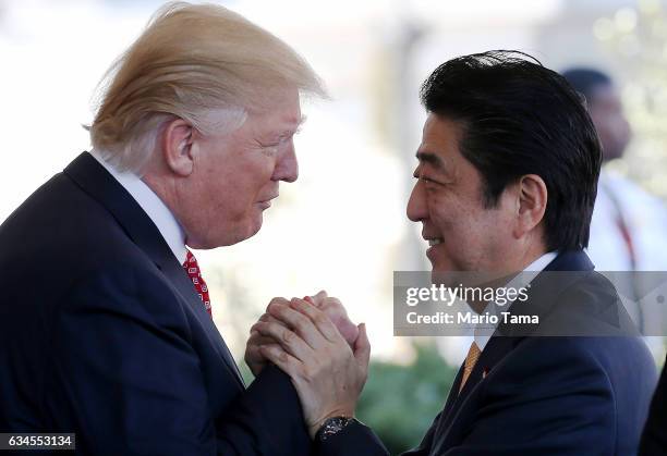 President Donald Trump greets Japanese Prime Minister Shinzo Abe as he arrives at the White House on February 10, 2017 in Washington, DC. The two...