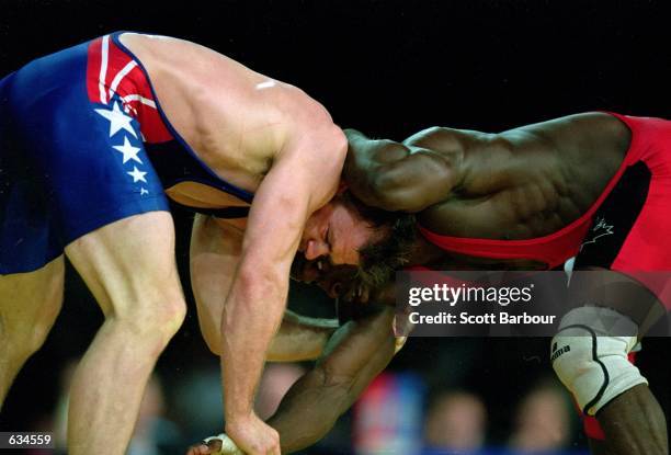 Linclon Mc Ilravy of the USA tries to flip Daniel Igali of Canada during the Men's Freestyle Wrestling 69kg Event at the Sydney Exhibition Hall for...