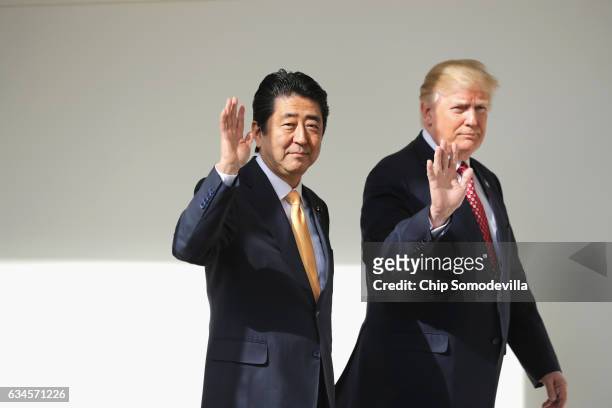 President Donald Trump and Japan Prime Minister Shinzo Abe walk together to their joint press conference in the East Room at the White House on...