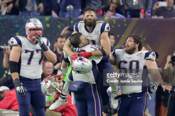 Tom Brady of the New England Patriots celebrates with Julian Edelman after defeating the Atlanta Falcons 34-28 in overtime to win Super Bowl 51 at...