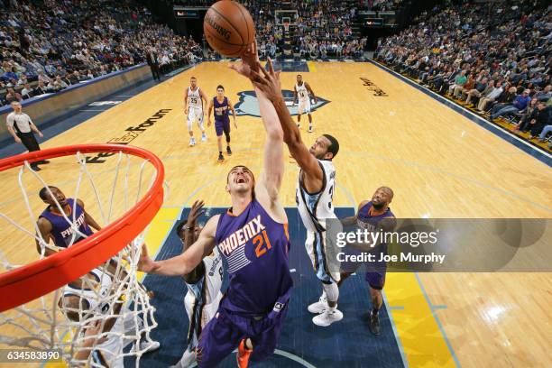 Alex Len of the Phoenix Suns and Brandan Wright of the Memphis Grizzlies go up for a rebound on February 8, 2017 at FedExForum in Memphis, Tennessee....