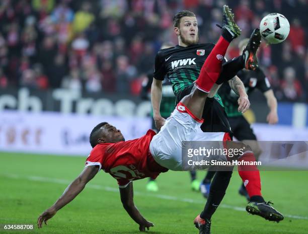 Jhon Cordoba of Mainz is challenged by Jeffrey Gouweleeuw of Augsburg during the Bundesliga match between 1. FSV Mainz 05 and FC Augsburg at Opel...