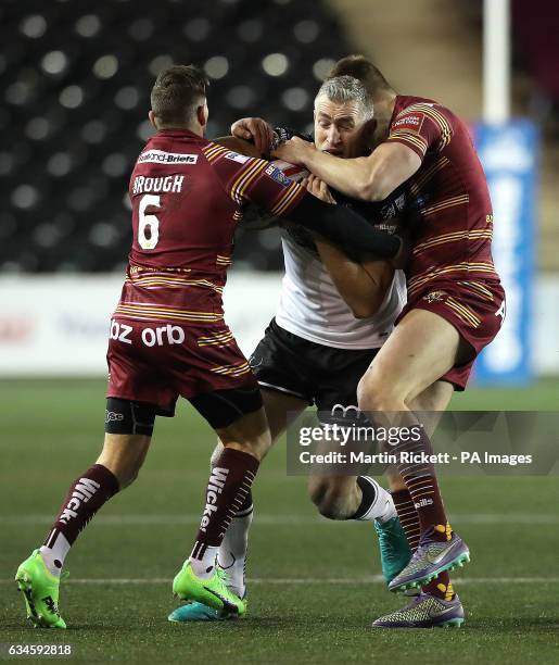 Widnes Vikings' Chris Houston is tackled by Huddersfield Giants' Danny Brough and Alex Mellor during the Super League match at the Select Security...