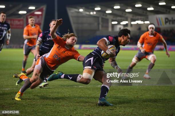 Denny Solomona of Sale Sharks beats Joel Hodgson of Newcastle Falcons to score a try during the Aviva Premiership match between Sale Sharks and...