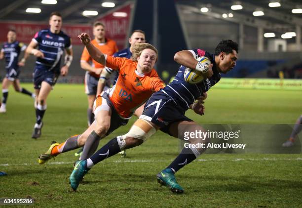 Denny Solomona of Sale Sharks beats Joel Hodgson of Newcastle Falcons to score a try during the Aviva Premiership match between Sale Sharks and...