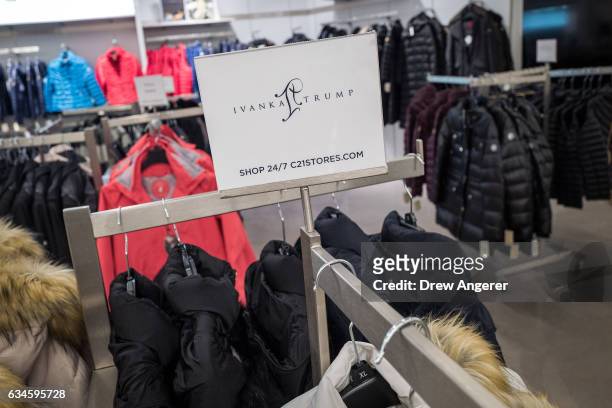 Sign for Ivanka Trump brand is displayed atop a rack of Ivanka Trump brand coats for sale at the Century 21 department store February 10, 2017 in New...