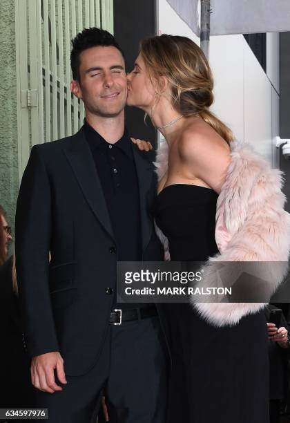Recording artist Adam Levine and wife model Behati Prinsloo kiss after he was honored with a Star on the Hollywood Walk of Fame in Hollywood,...