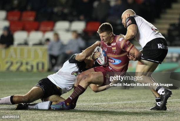 Huddersfield Giants' Alex Mellor is tackled by Widnes' Sam Wood and Gil Dudson , during the Super League match at the Select Security Stadium, Widnes.