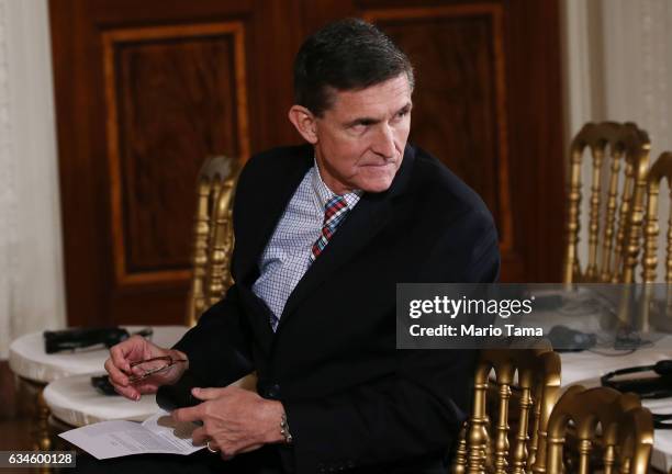 National Security Adviser Michael Flynn sits before U.S. President Donald Trump and Japanese Prime Minister Shinzo Abe hold a joint press conference...