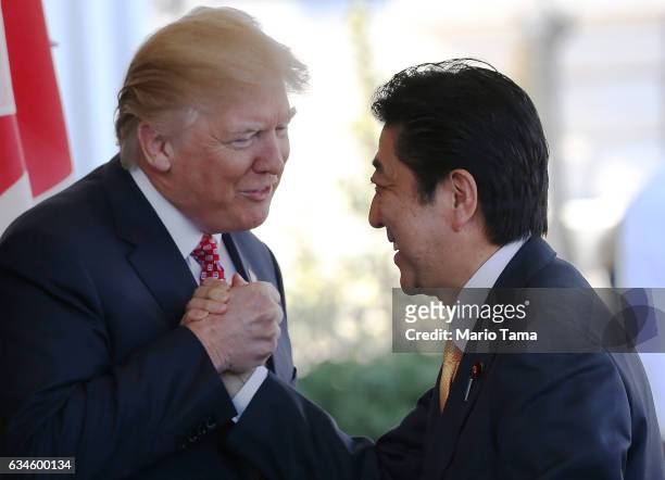 President Donald Trump greets Japanese Prime Minister Shinzo Abe as he arrives at the White House on February 10, 2017 in Washington, DC. The two...