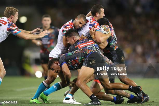 Reagan Campbell-Gillard of the World All Stars is tackled by the Indigenous All Stars defence during the NRL All Stars match between the 2017 Harvey...