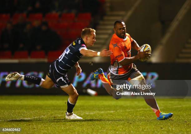 Vereniki Goneva of Newcastle Falcons beats a challenge from Mike Haley of Sale Sharks to score his third try during the Aviva Premiership match...
