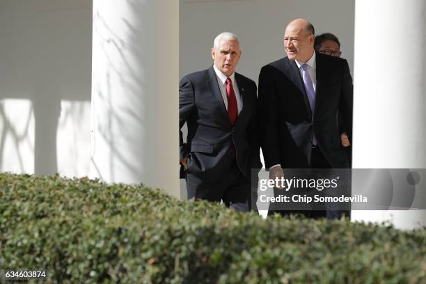 Vice President Mike Pence and Director of the National Economic Council Gary Cohn walk down the West Wing Colonnade following a bilateral meeting...