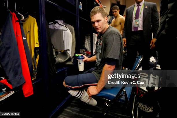 Tom Brady of the New England Patriots looks for his missing jersey in the locker room after defeating the Atlanta Falcons during Super Bowl 51 at NRG...