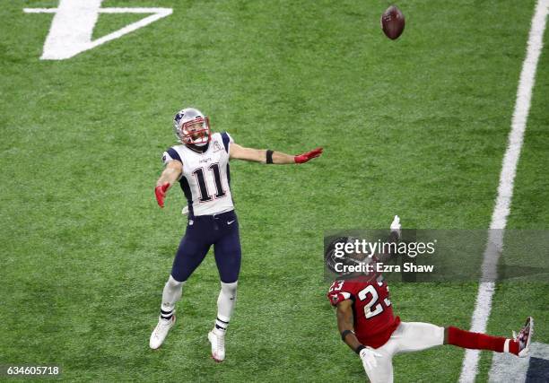 Julian Edelman of the New England Patriots positions himself to make a 23-yard catch in the fourth quarter against Robert Alford and Keanu Neal of...