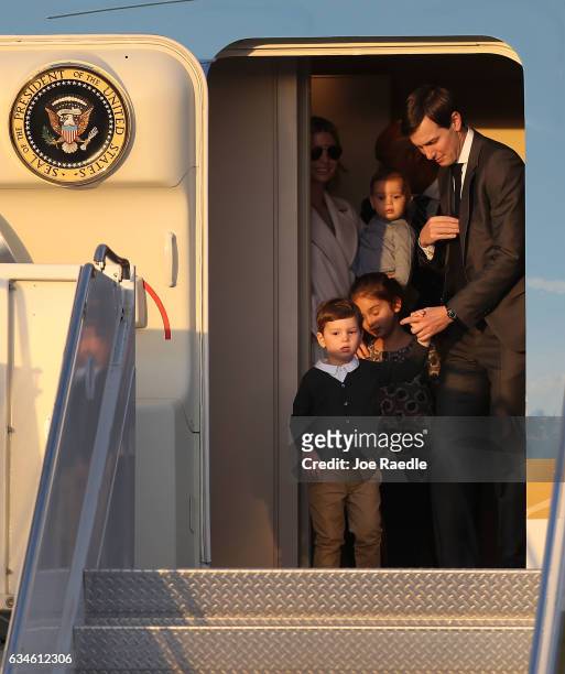Jared Kushner and his wife Ivanka Trump walk off Air Force One with their children at Palm Beach International airport as they prepare to spend part...