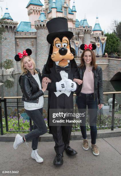 In this handout photo provided by Disney Parks, "Downton Abbey" stars Laura Carmichael and Michelle Dockery meet Goofy at Sleeping Beauty Castle at...