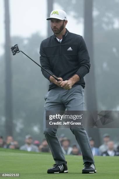 Dustin Johnson reacts to a missed birdie putt on the 18th green during Round Two of the AT&T Pebble Beach Pro-Am at Spyglass Hill Golf Course on...