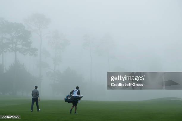 Jordan Spieth walks with his caddie on the 9th hole during Round Two of the AT&T Pebble Beach Pro-Am at Spyglass Hill Golf Course on February 10,...
