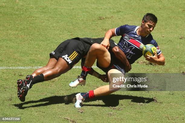 Jack Maddocks of the Rebels is tackled by Tauke'iaho of the Chiefs during the Rugby Global Tens match between Rebels and Chiefs at Suncorp Stadium on...
