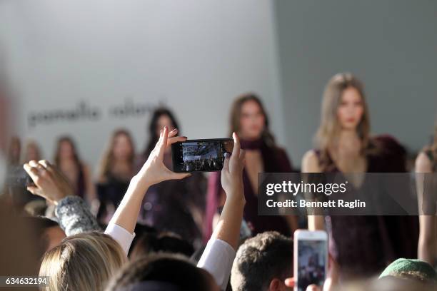 Guest takes a cell phone pictures during the Pamella Roland fashion show during New York Fashion Week at Pier 59 Studios on February 10, 2017 in New...