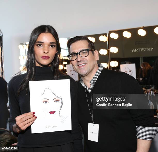 Make up artist Rick DiCecca poses model backstage during the Pamella Roland fashion show during New York Fashion Week at Pier 59 Studios on February...