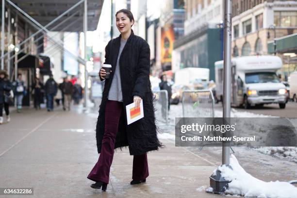 Caroline Issa is seen attending Calvin Klein during New York Fashion Week wearing a long black coat with fringe, and merlot pants on February 10,...