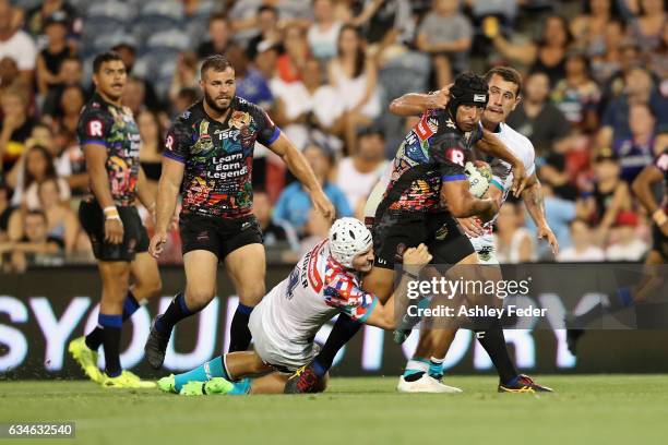 Johnathan Thurston of Indigenous All Stars is tackled by Jarrod Croker of World All Stars during the NRL All Stars match between the 2017 Harvey...