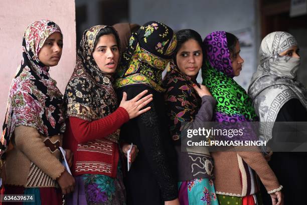 Muslim women queue to cast their votes at a polling station in Muzaffarnagar in Uttar Pradesh on February 11, 2017. India's most populous state Uttar...