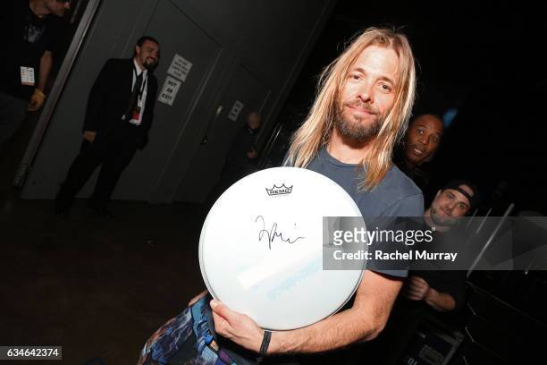 Musician Taylor Hawkins of the Foo Fighters poses with the charity signings at MusiCares Person of the Year honoring Tom Petty during the 59th GRAMMY...