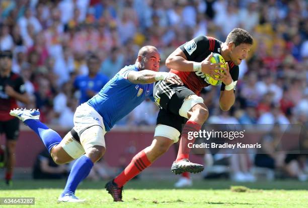Whetu Douglas of the Crusaders attempts to break away from the defence during the Rugby Global Tens match between the Crusaders and Samoa at Suncorp...