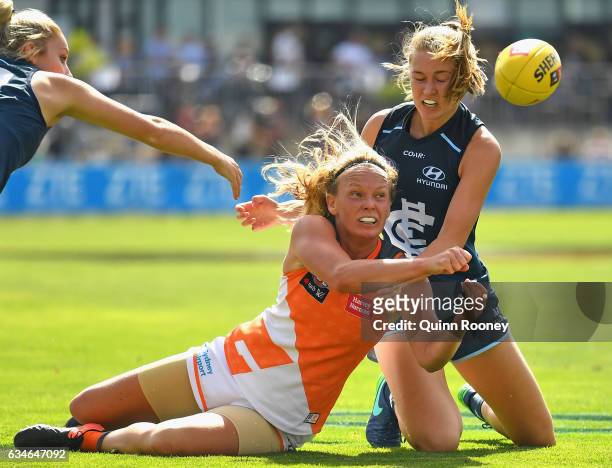 Phoebe McWilliams of the Giants handballs whilst being tackled during the round two AFL Women's match between the Carlton Blues and the Greater...